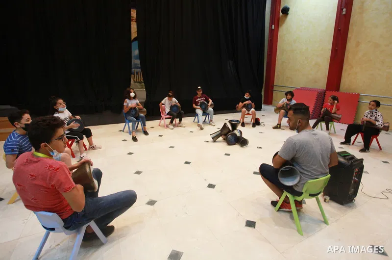 Palestinian children attend a class to learn Darbuka (goblet drum) at Qattan Foundation in Gaza city on July 29, 2021. With schools shuttered due to coronavirus and the summer hiatus, Gaza's children have little to keep...