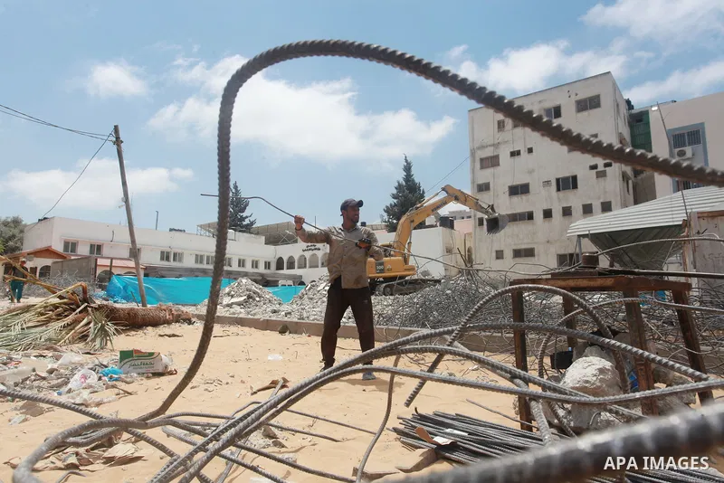 Palestinian workers recycle steel bars from a building destroyed by Israeli air strikes during the recent 11-day conflict between Isarel and Hamas on May, in Gaza city on July 29, 2021. Human Rights Watch said today that...