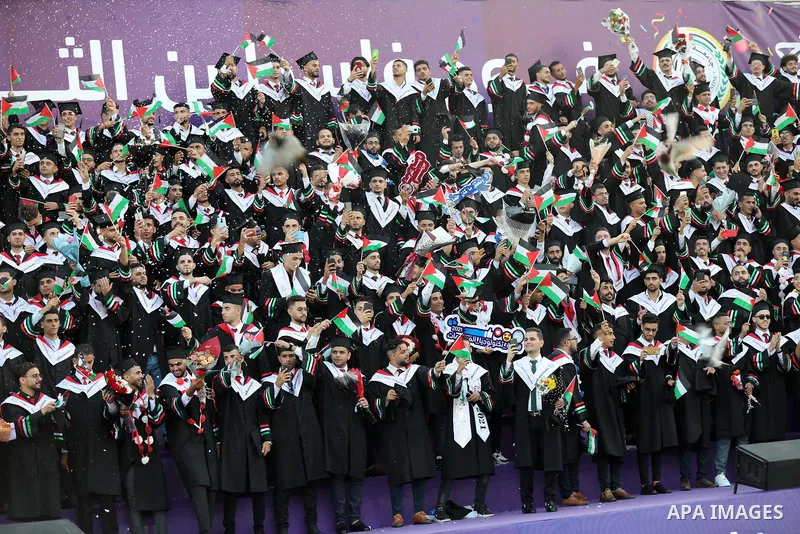 Palestinian students attend their graduation ceremony at Palestine university at Al-Zahra city in the center of Gaza Strip on July 29, 2021. Photo by Ashraf Amra