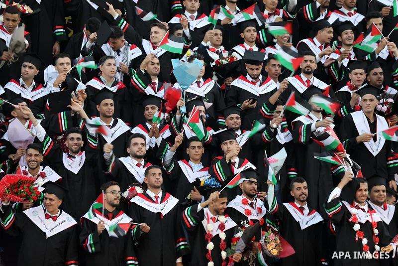 Palestinian students attend their graduation ceremony at Palestine university at Al-Zahra city in the center of Gaza Strip on July 29, 2021. Photo by Ashraf Amra