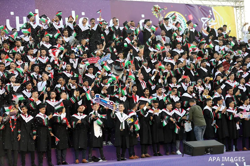 Palestinian students attend their graduation ceremony at Palestine university at Al-Zahra city in the center of Gaza Strip on July 29, 2021. Photo by Ashraf Amra