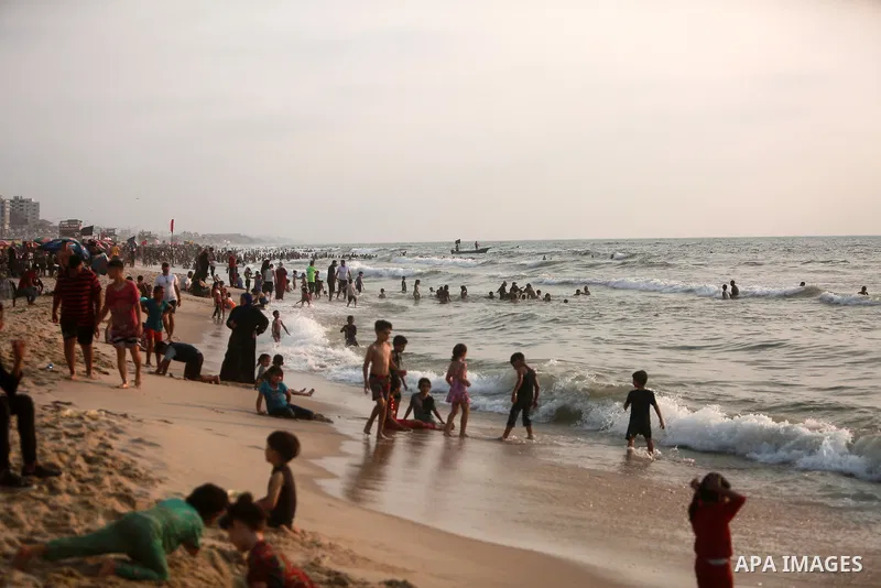 Palestinians enjoy the beach of the Mediterranean sea in Gaza City, on July 30, 2021. The beach is one of the few open public spaces in this densely populated city. Photo by Mohammed Dahman