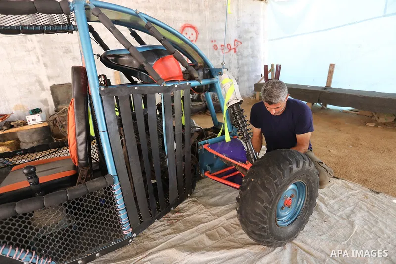 Palestinian Fathi Abu Gharaba, 46, invents a racing car in Maghazi refugee camp in the central Gaza Strip, on July 31, 2021. Using scrap materials and rudimentary equipment at a cost of US$3500, Abu Gharaba produces a "d...