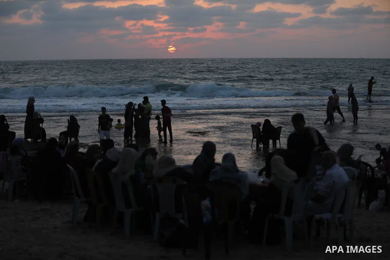 Palestinians enjoy the beach of the Mediterranean sea in Gaza City, on July 31, 2021. The beach is one of the few open public spaces in this densely populated city. Photo by Ashraf Amra