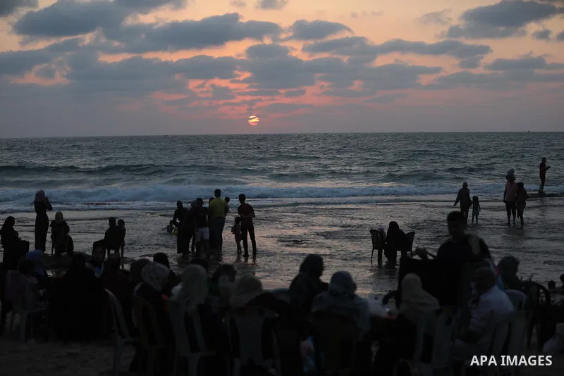Palestinians enjoy the beach of the Mediterranean sea in Gaza City, on July 31, 2021. The beach is one of the few open public spaces in this densely populated city. Photo by Ashraf Amra