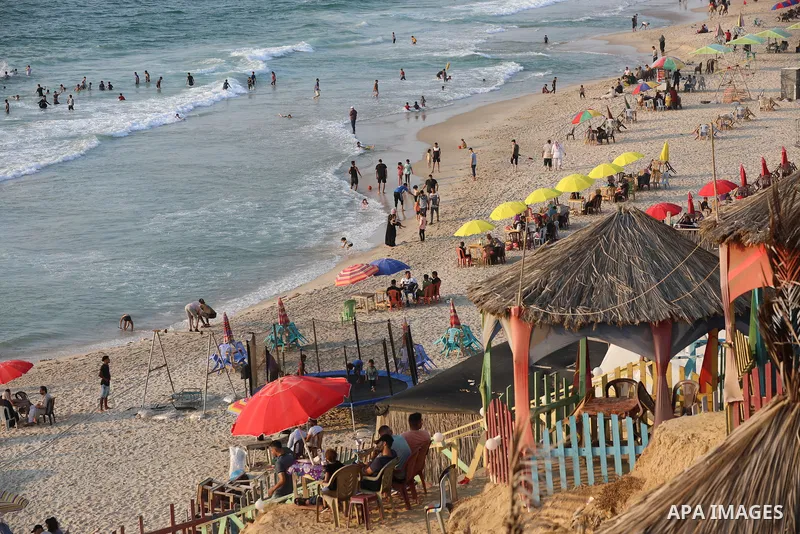 Palestinians enjoy the beach of the Mediterranean sea in Gaza City, on July 31, 2021. The beach is one of the few open public spaces in this densely populated city. Photo by Ashraf Amra