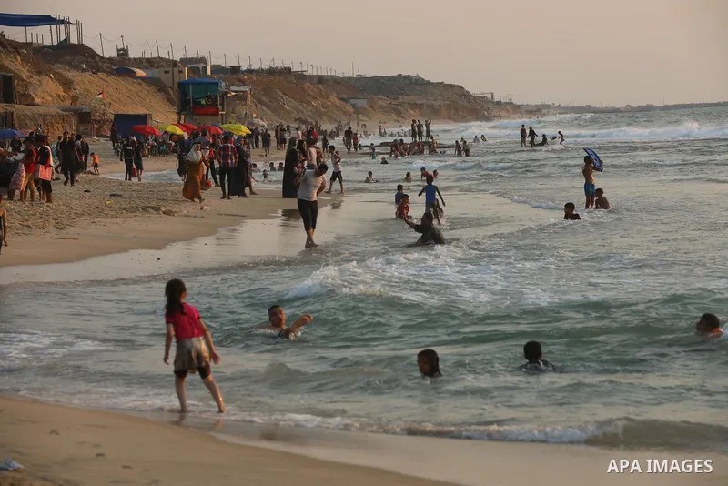 Palestinians enjoy the beach of the Mediterranean sea in Gaza City, on July 31, 2021. The beach is one of the few open public spaces in this densely populated city. Photo by Ashraf Amra