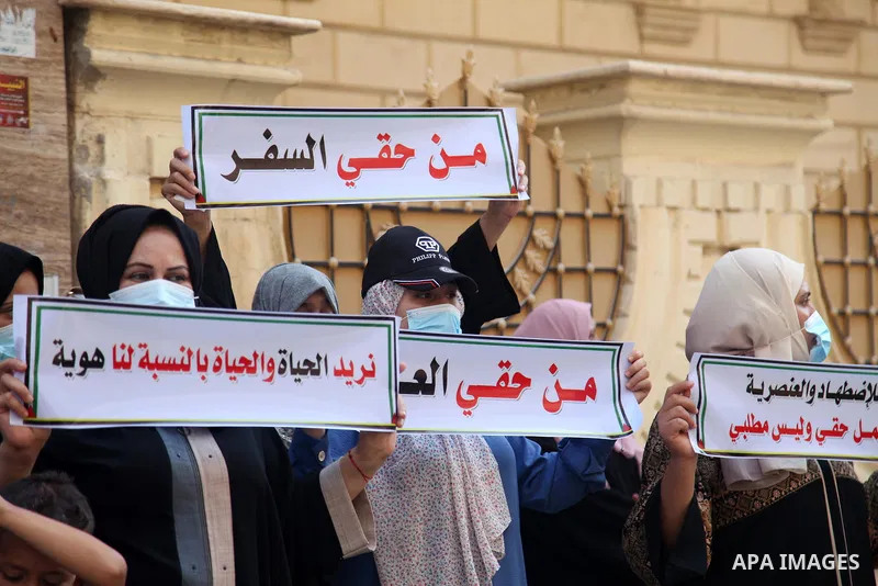 Palestinians hold IDs and banners to demand of the family reunification in Gaza city, on August 01, 2021. Thousands of Palestinians have suffered as a result of the law, which the Israeli government claims was enacted fo...
