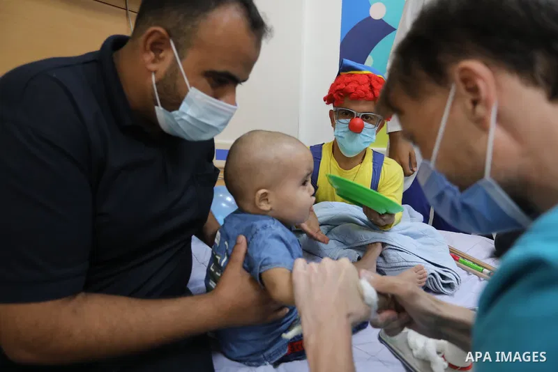 Palestinian clowns play with a child with cancer at el-Rantisi hospital in Gaza city on August 01, 2021. 2020 has been a rough year for cancer patients in the Gaza Strip. The usual restrictions and blockade were compound...
