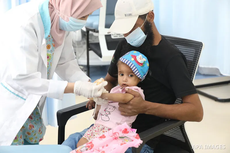 Palestinian clowns play with a child with cancer at el-Rantisi hospital in Gaza city on August 01, 2021. 2020 has been a rough year for cancer patients in the Gaza Strip. The usual restrictions and blockade were compound...