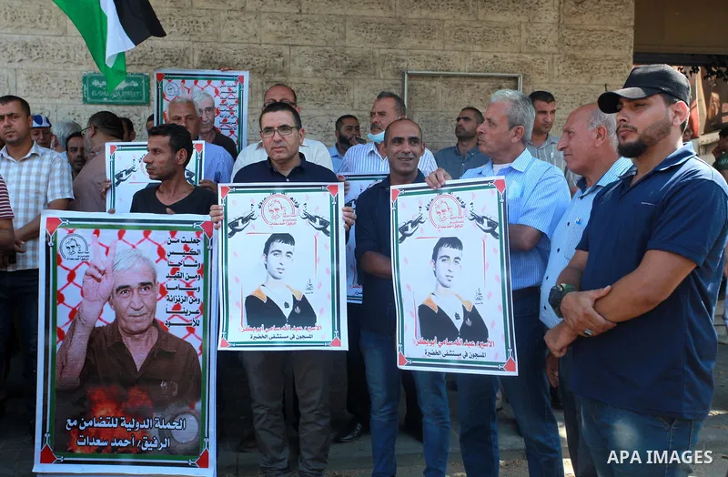 Palestinians take part in a protest to show solidarity with prisoners on hunger strike in Israeli Jails, in front of the headquarters of Red cross in Gaza city on August 02, 2021. A total of 17 Palestinian prisoners in I...