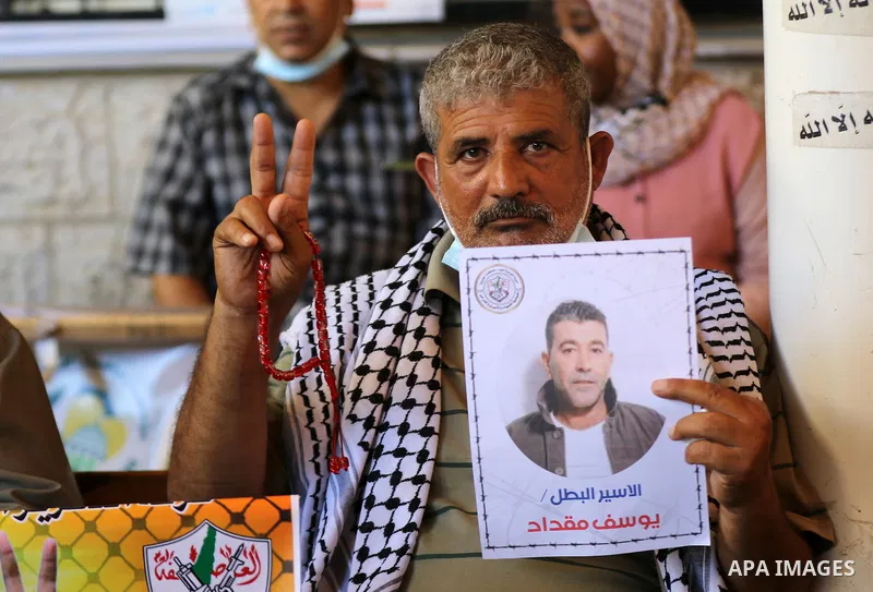Palestinians take part in a protest to show solidarity with prisoners on hunger strike in Israeli Jails, in front of the headquarters of Red cross in Gaza city on August 02, 2021. A total of 17 Palestinian prisoners in I...
