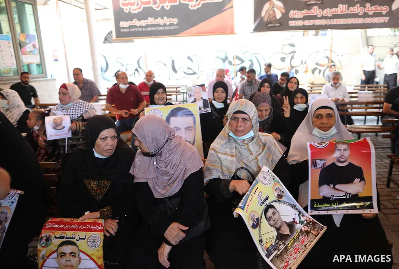 Palestinians take part in a protest to show solidarity with prisoners on hunger strike in Israeli Jails, in front of the headquarters of Red cross in Gaza city on August 02, 2021. A total of 17 Palestinian prisoners in I...