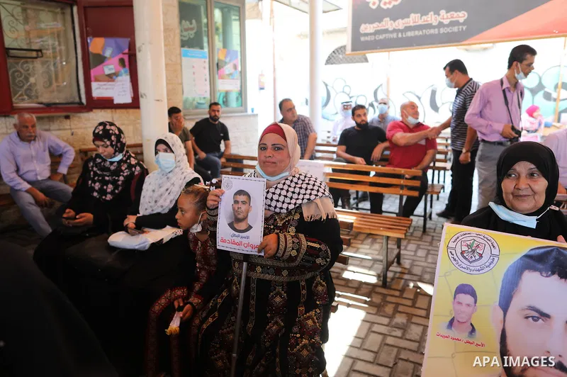 Palestinians take part in a protest to show solidarity with prisoners on hunger strike in Israeli Jails, in front of the headquarters of Red cross in Gaza city on August 02, 2021. A total of 17 Palestinian prisoners in I...