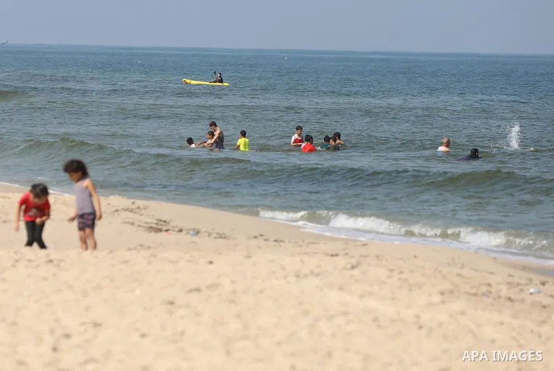Palestinians enjoy the beach of the Mediterranean sea in Gaza City, on August 2, 2021. The beach is one of the few open public spaces in this densely populated city. Photo by Ashraf Amra