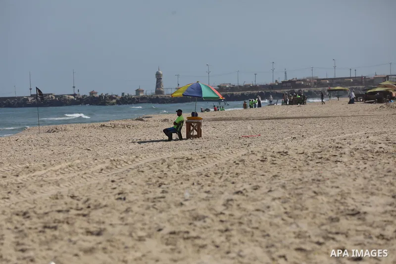 Palestinians enjoy the beach of the Mediterranean sea in Gaza City, on August 2, 2021. The beach is one of the few open public spaces in this densely populated city. Photo by Ashraf Amra