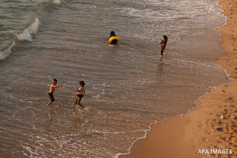 Palestinians enjoy the beach of the Mediterranean sea in Gaza City, on August 1, 2021. The beach is one of the few open public spaces in this densely populated city. Photo by Osama Baba
