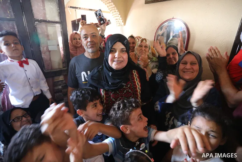 A Palestinian high school female student, Maha Al-Hussaini, 51 years old, 91.9%, celebrates with her family after heard the results of her final exams known as ''Tawjihi'', in Khan Younis in the southern of Gaza strip on...