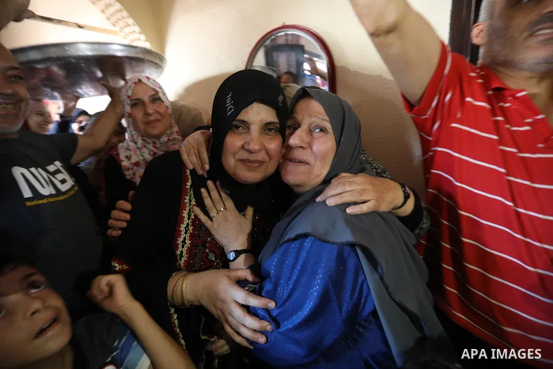 A Palestinian high school female student, Maha Al-Hussaini, 51 years old, 91.9%, celebrates with her family after heard the results of her final exams known as ''Tawjihi'', in Khan Younis in the southern of Gaza strip on...