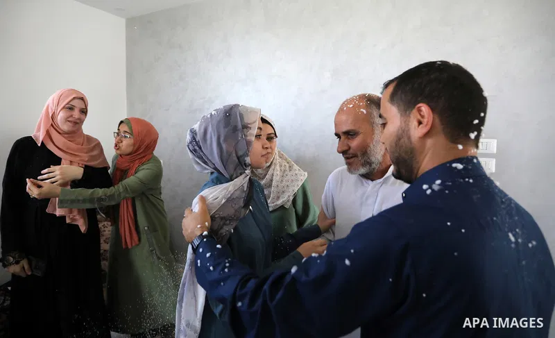 A Palestinian high school female student, Alaa Ahmed, 99.7%, celebrates with her family after heard the results of her final exams known as ''Tawjihi'', in Khan Younis in the southern of Gaza strip on August 3, 2021. Pho...