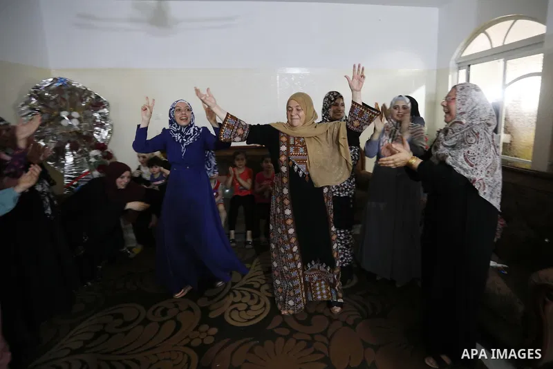 A Palestinian high school female student, lama Zaqot, 99.7%, celebrates with her family after heard the results of her final exams known as ''Tawjihi'', in Khan Younis in the southern of Gaza strip on August 3, 2021. Pho...