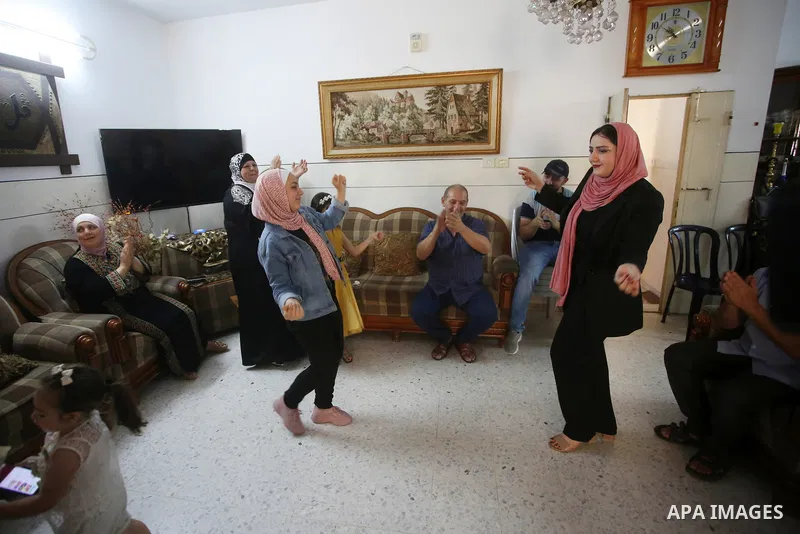 A Palestinian high school female student, Tala Hajab, 99.7%, celebrates with her family after heard the results of her final exams known as ''Tawjihi'', in the West Bank city of Nablus on August 3, 2021. Photo by Shadi J...
