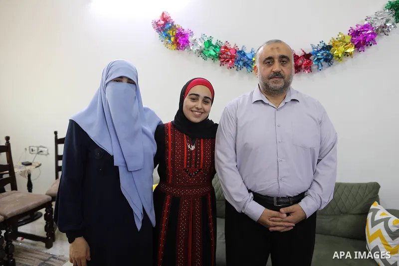 A Palestinian high school female student, Wafaa Fares, 99.7%, celebrates with her family after heard the results of her final exams known as ''Tawjihi'', in Gaza city on August 3, 2021. Photo by Mahmoud Naser