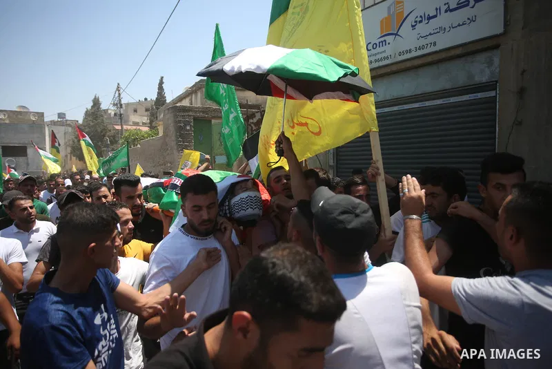 Mourners attend the funeral of Palestinian Mohammad Fareed Hasan, who was killed by Israeli gunfire, in the village of Qusra near the city Nablus on August 4, 2021, after Israel handed over his body today. A Palestinian...