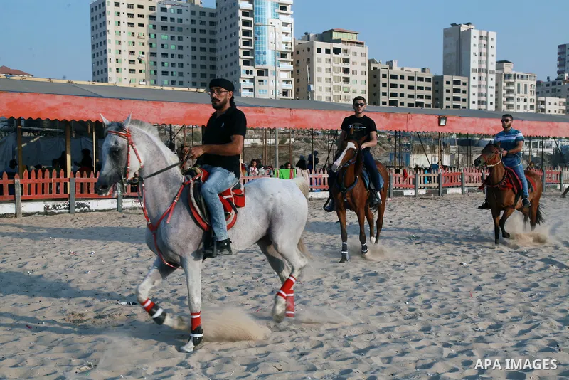 Palestinians enjoy the beach of the Mediterranean sea in Gaza City, on August 6, 2021. The beach is one of the few open public spaces in this densely populated city. Photo by Omar Ashtawy