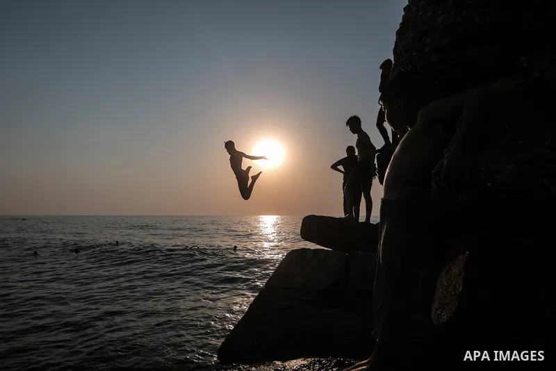 Palestinians enjoy their time at the beach of Gaza sea during a hot day on August 6, 2021. The beach is one of the few open public spaces in this densely populated city. Photo by Mohammed Dahman