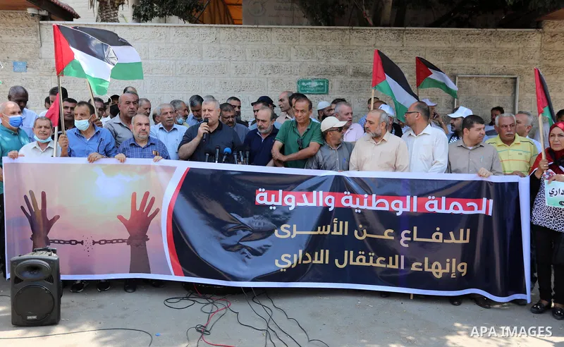 Palestinian members of the National and Islamic forces, take part in a protest to show solidarity with prisoners on hunger strike in Israeli Jails, in front of the headquarters of Red cross in Gaza city on August 08, 202...