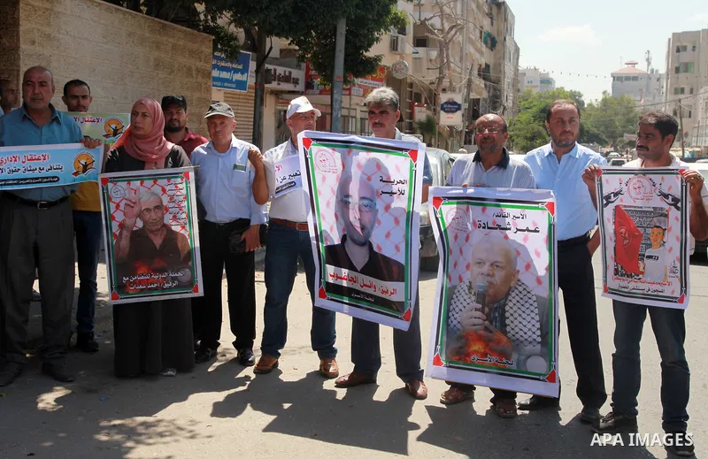 Palestinian supporters of the Popular Front for the Liberation of Palestine, take part in a protest to show solidarity with prisoners on hunger strike in Israeli Jails, in front of the headquarters of Red cross in Gaza c...