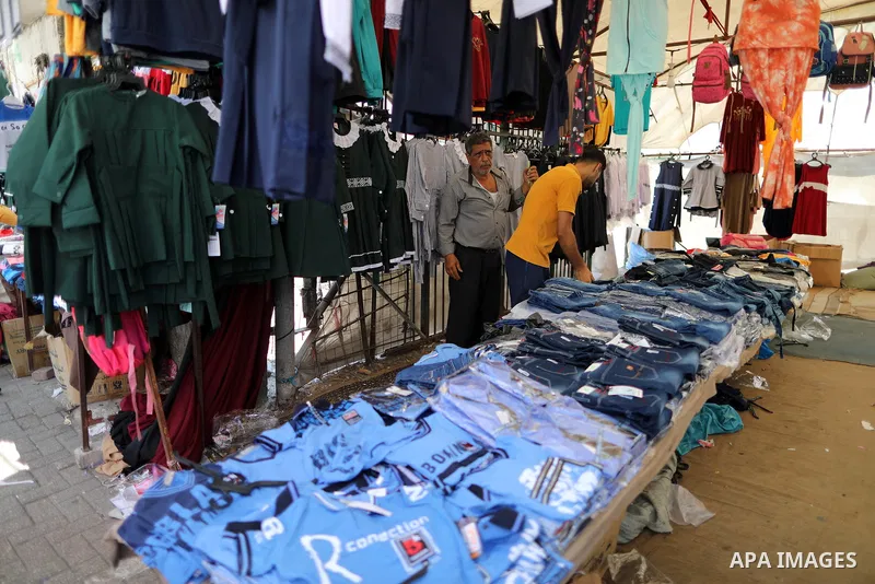 Palestinians shop during preparation for the new school year at a market in Gaza city, on 11 August 2021. The fiscal position in Gaza strip has worsened not only due to the outbreak but also due to a political standoff t...
