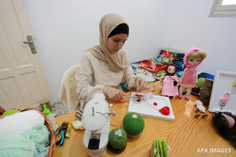 Palestinian Basma Mahmoud, 33, makes dolls Crochet Wool "Amigurami art" at her home in Gaza City, on August 12, 2021. Amigurami is a Japanese art that uses crochet or knitting to make dolls such as geometric shapes, food...