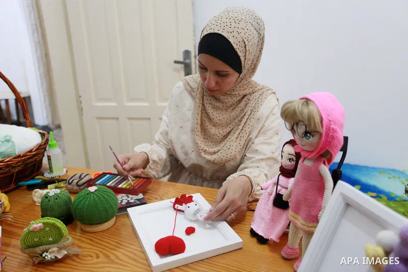 Palestinian Basma Mahmoud, 33, makes dolls Crochet Wool "Amigurami art" at her home in Gaza City, on August 12, 2021. Amigurami is a Japanese art that uses crochet or knitting to make dolls such as geometric shapes, food...