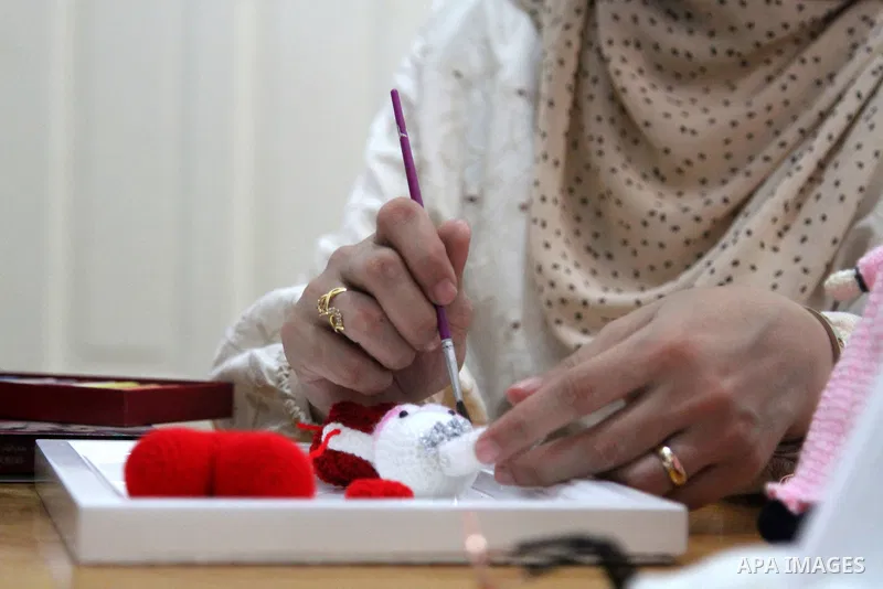 Palestinian Basma Mahmoud, 33, makes dolls Crochet Wool "Amigurami art" at her home in Gaza City, on August 12, 2021. Amigurami is a Japanese art that uses crochet or knitting to make dolls such as geometric shapes, food...