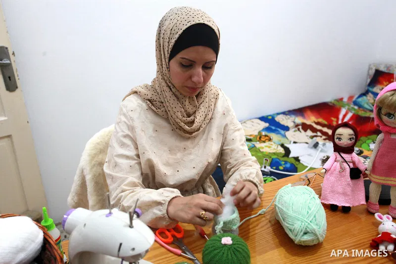 Palestinian Basma Mahmoud, 33, makes dolls Crochet Wool "Amigurami art" at her home in Gaza City, on August 12, 2021. Amigurami is a Japanese art that uses crochet or knitting to make dolls such as geometric shapes, food...