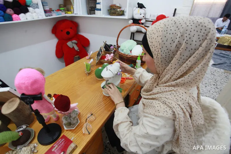 Palestinian Basma Mahmoud, 33, makes dolls Crochet Wool "Amigurami art" at her home in Gaza City, on August 12, 2021. Amigurami is a Japanese art that uses crochet or knitting to make dolls such as geometric shapes, food...