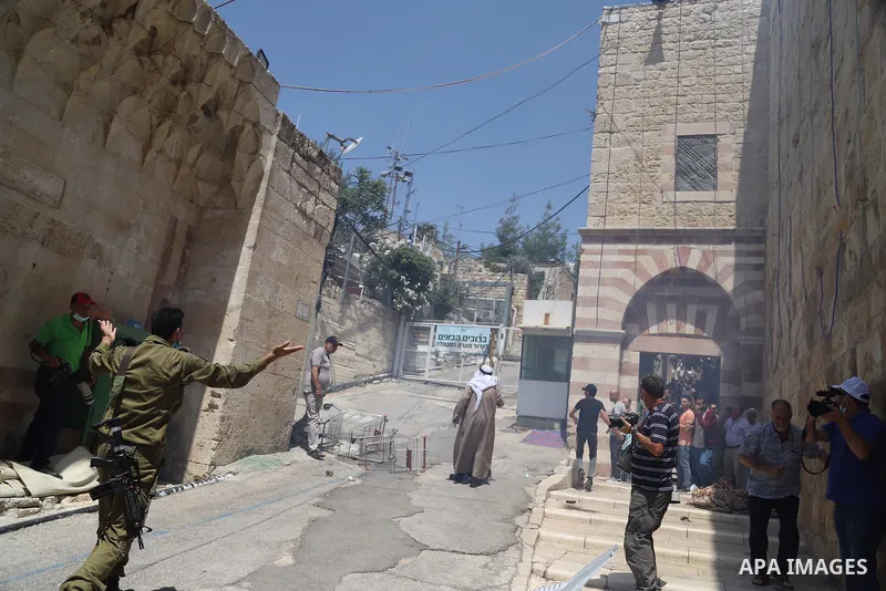 Israeli security forces argue with Palestinian worshippers during a demonstration following the Friday prayers at the Ibrahimi mosque (Tomb of the Patriarchs) denouncing Israeli construction plans at the site, in the div...