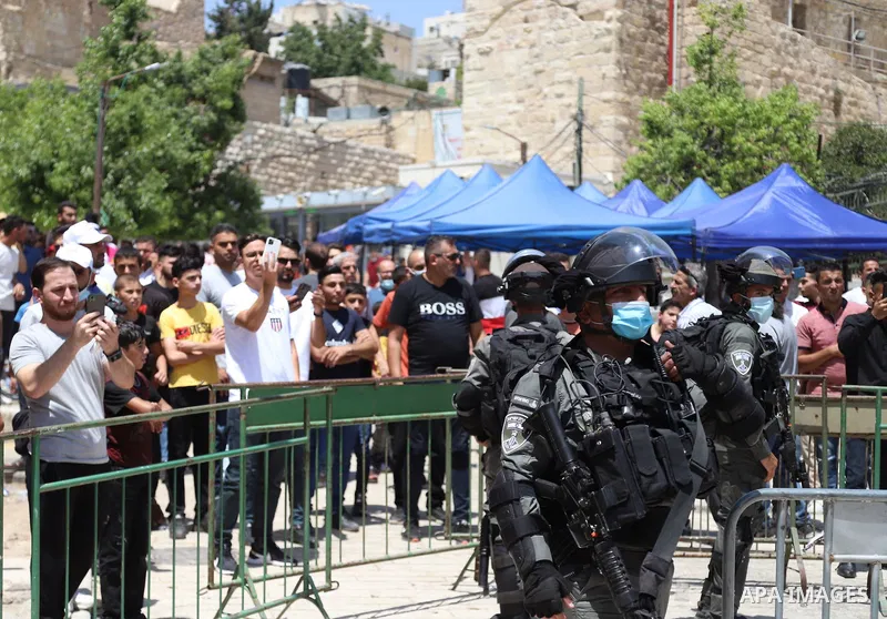 Israeli security forces argue with Palestinian worshippers during a demonstration following the Friday prayers at the Ibrahimi mosque (Tomb of the Patriarchs) denouncing Israeli construction plans at the site, in the div...