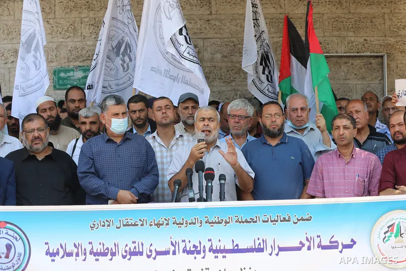 Palestinian supporters of the Al-ahrar Movement, take part in a protest to show solidarity with prisoners on hunger strike in Israeli Jails, in front of the headquarters of Red cross in Gaza city on August 14, 2021. The...