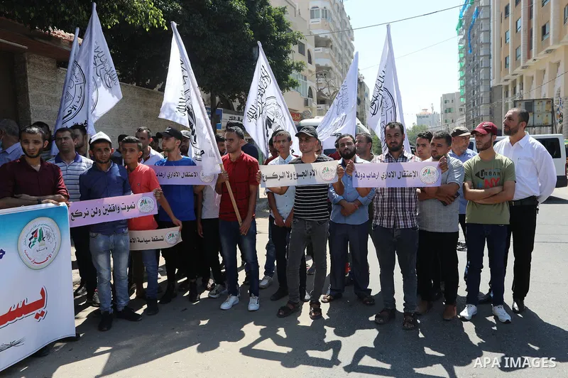 Palestinian supporters of the Al-ahrar Movement, take part in a protest to show solidarity with prisoners on hunger strike in Israeli Jails, in front of the headquarters of Red cross in Gaza city on August 14, 2021. The...