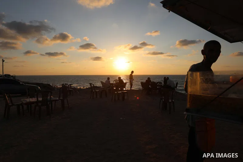 Palestinian graduates work on a small cafe "Tomanco", on the beach of the Mediterranean sea in Deir al-Balah in the central Gaza Strip, on August 14, 2021. Palestinian Abu Shadi Toman opened a small cafe on the beach of...