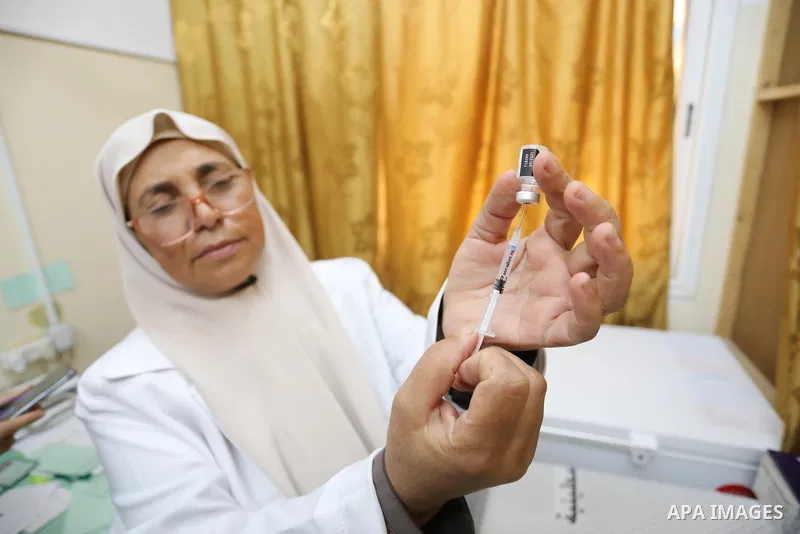 Palestinians receive the dose of the coronavirus disease (COVID-19) vaccine at a clininc, in Deir al-Balah in the central Gaza Strip on August 15, 2021. Concerning rollout of vaccines, the health minister said over 638,0...