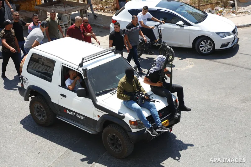 Palestinian mourners carry the body of Raed Abu Seif and Saleh Ammar, two of four Palestinians killed in clashes with Israeli security forces earlier in the day, during their funeral in the Jenin refugee camp in the nort...