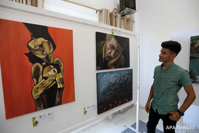 Palestinians participate in an art exhibition on the occasion of International Youth Day in Gaza City on August 16, 2021. Photo by Ashraf Amra