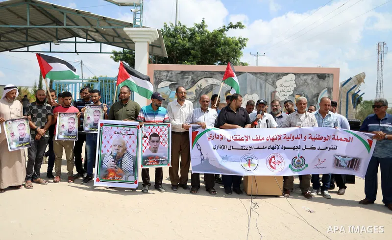 Palestinians take part in a protest to show solidarity with prisoners on hunger strike in Israeli Jails, in front of Erez crossing, in Beit Hanoun in the northern Gaza Strip, on August 22, 2021. Nine Palestinian prisoner...