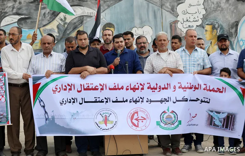 Palestinians take part in a protest to show solidarity with prisoners on hunger strike in Israeli Jails, in front of Erez crossing, in Beit Hanoun in the northern Gaza Strip, on August 22, 2021. Nine Palestinian prisoner...