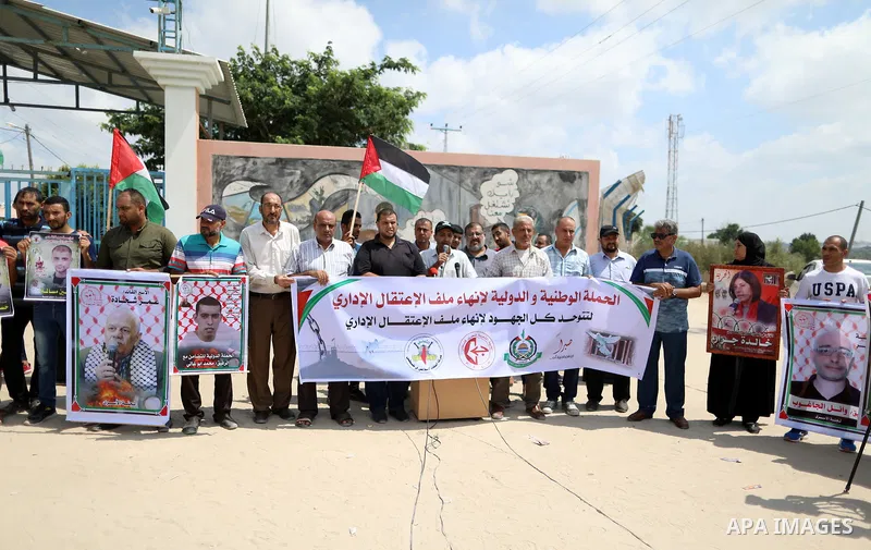 Palestinians take part in a protest to show solidarity with prisoners on hunger strike in Israeli Jails, in front of Erez crossing, in Beit Hanoun in the northern Gaza Strip, on August 22, 2021. Nine Palestinian prisoner...