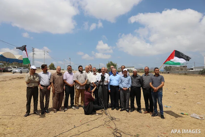 Palestinians members of National and Islamic forces hold a press conference near the Israel-Gaza border, east of Gaza City, denouncing the Israeli siege of the Palestinian strip, on August 22, 2021. Israeli fighter jets...